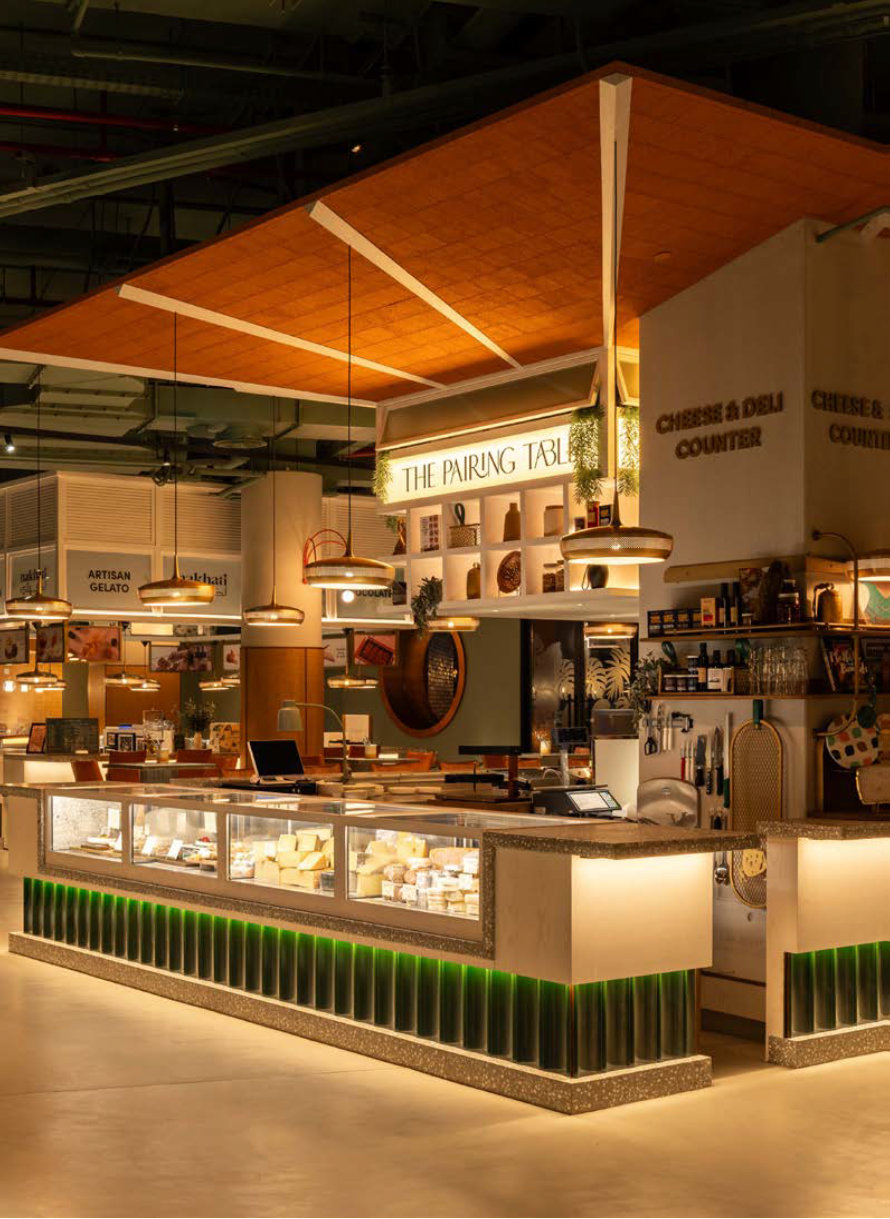 The Pairing Table at Al Mamlaka blending retail and restaurant interior design in Saudi Arabia.